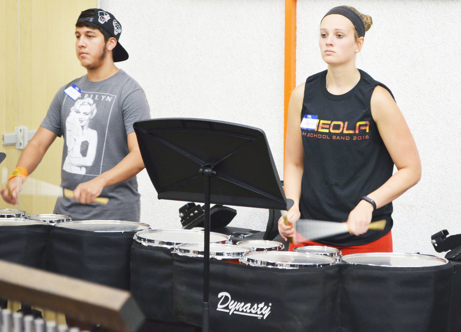 From left, freshman Anjel Garcia and senior drum caption Hannah Valek focus on early morning warm-ups during percussion camp last week at the Mineola High School Band Hall. The percussion line, color guard and leadership team held their own camps before full band camp that began this week on Monday. (Monitor photo by Evan Dudley)