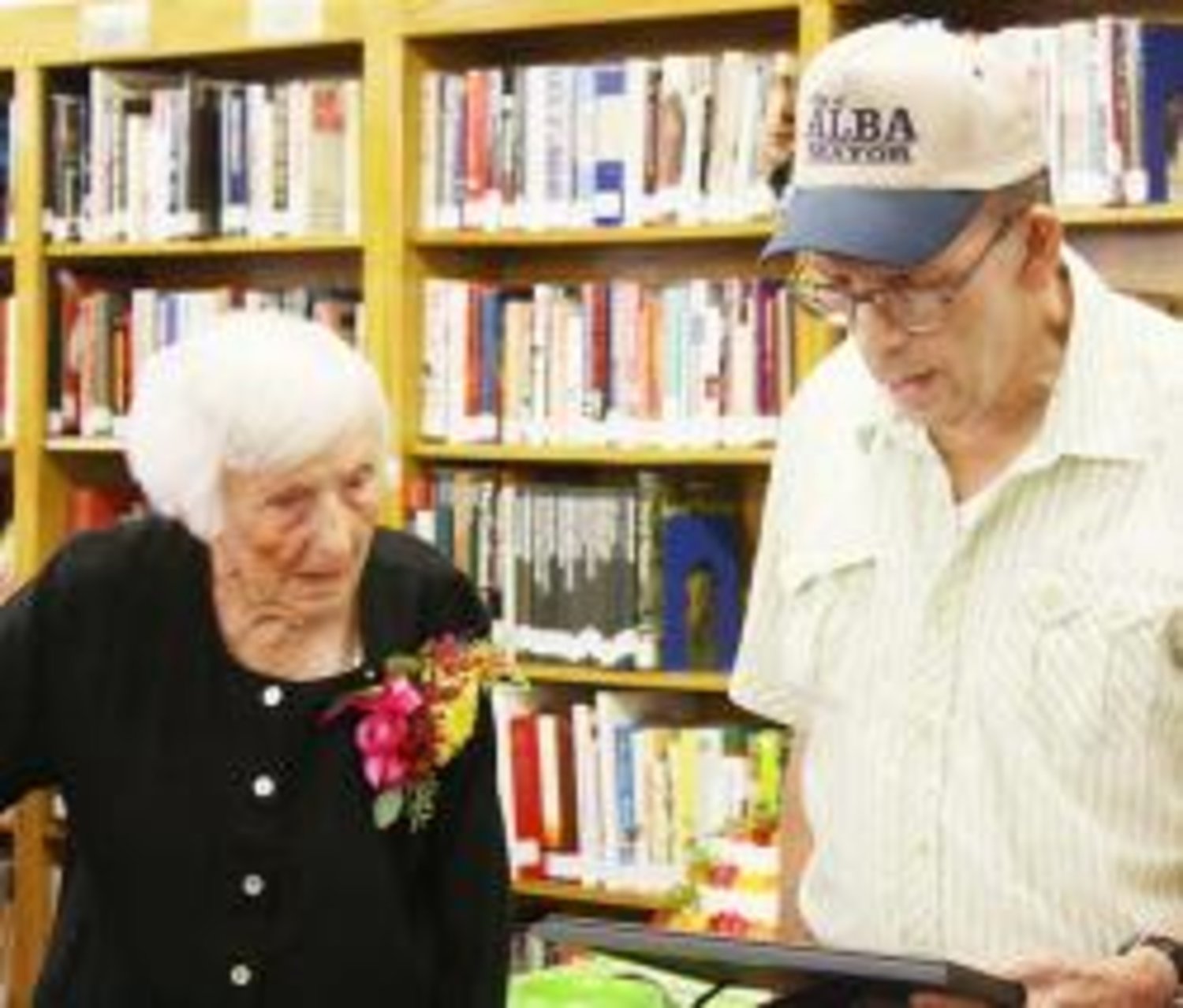 Hazel Panter of Alba receives a proclamation from Alba Mayor Orvin Carroll, who designated Aug. 29 as Hazel Panter Day in honor of her 100th birthday. Carroll said this was the first time he had ever issued a proclamation. A group of Panter's family, friends and other acquaintances gathered to celebrate the day at the Alba Public Library in the morning of Aug. 29.
