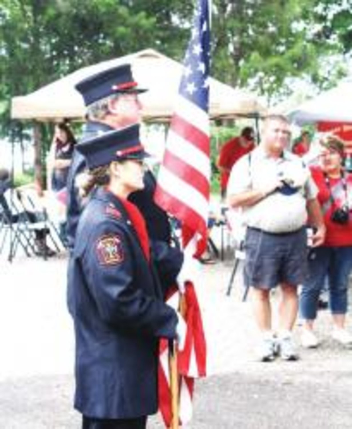 Wood County Color Guard members Wesley Crist and Tammy Gilmore stand at attention before post colors at Saturday's July 4th activities at Jim Hogg City Park.