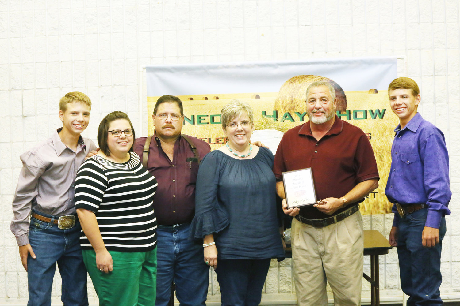 The Mineola Packing Company family continued the tradition of buying the first place hay entered in this year’s show by Jody Holmes, second from right.  The Lees are, from left, Josh, Jennifer, Jim, Susan and Jake, far right.