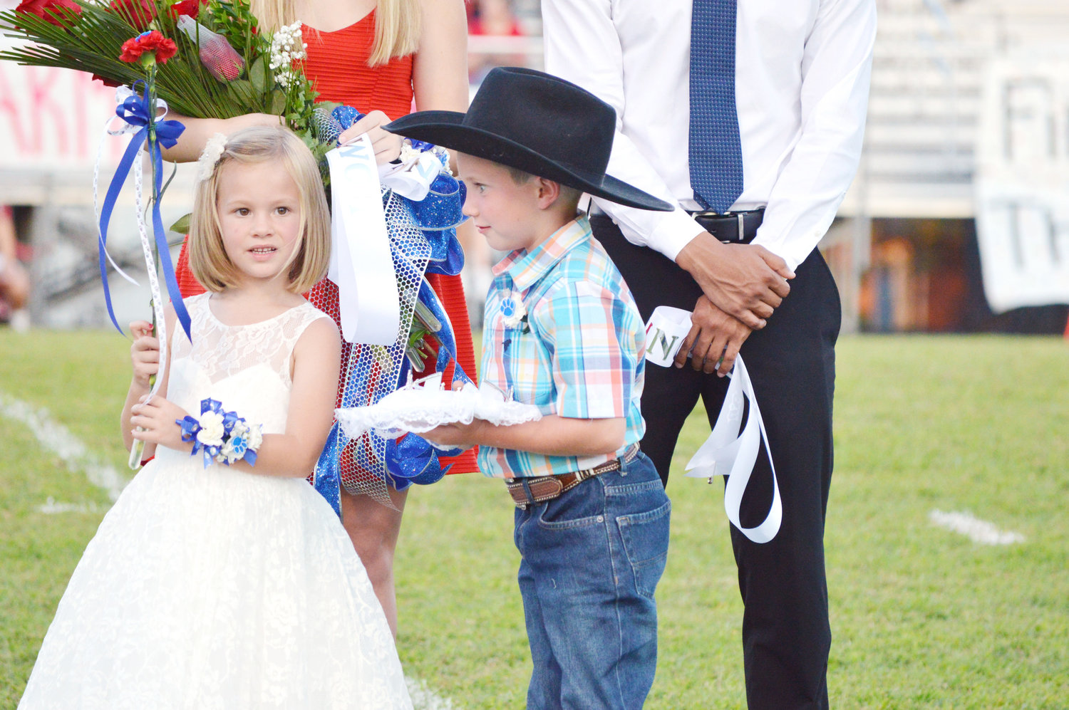 Flower girl Lola Hayes and the crown bearer Jake Perkins did a great job Friday night at homecoming honoring the new queen and king.