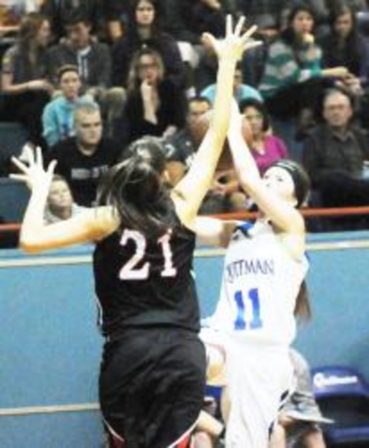Alyssa Harris attempts to shoot over the outstretched hands of the 5' 9" Bailey Swanner during fourth quarter action.
