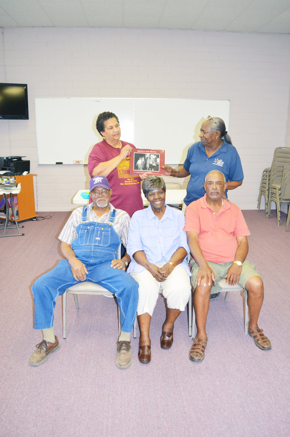 Clarence Slayton, Virginia McCalla and Edward Dickey share memories of the Bar 20, as well as memories of R.C. Hickman and Willie Brown, one afternoon recently at the McFarland Center. In the back are Debra McCalla and Brenda Hunt with a book that is a collection of Hickman’s photos.
