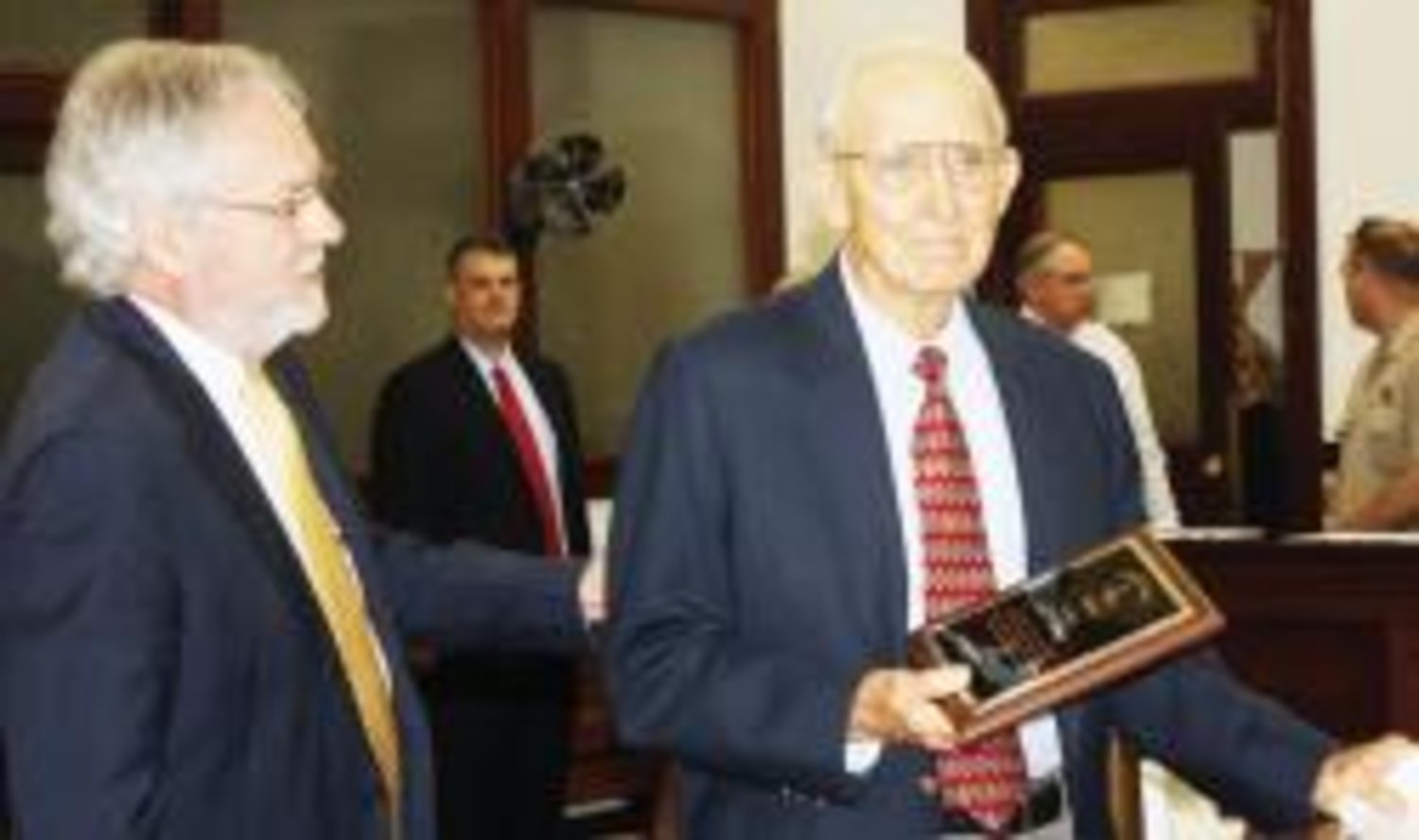 Bill Jones (right) is shown here receiving the Liberty Bell Award from Wood County Bar Association President Ted Beatty.
