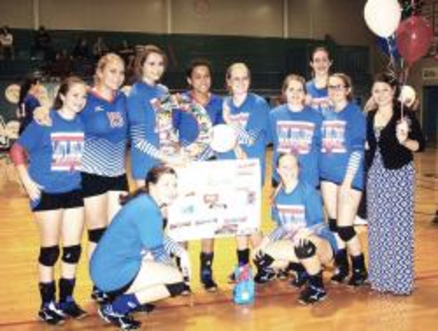 Senior Dawn Houck (holding volleyball in center) is surrounded by her teammates and Coach Ashlee Lingo honoring her on Senior Night last Friday after the Lady Bulldogs defeated Alba-Golden in a key district game.
