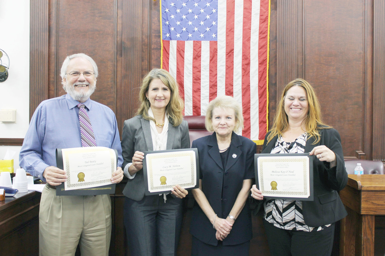 Attorneys Ted Beaty of Winnsboro, Lucy Hebron of Mineola (on left and second from left) and Melissa O’Neal, right, flank Dana Bias of Lone Star Legal aid. The three local attorneys were honored for giving back to their community. Lone Star Legal Aid is seeking other attorneys willing to do pro bono work. (Monitor photo by Doris Newman)