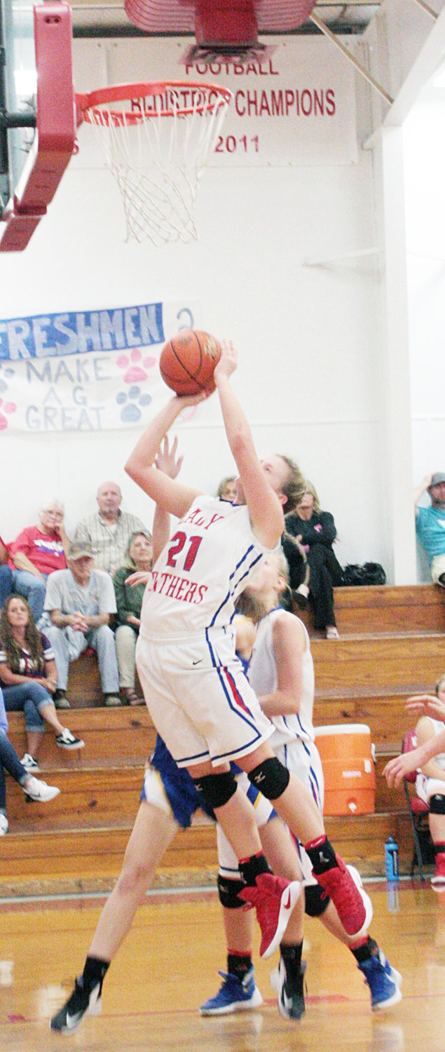 Kinzie Chadwick (21) polishes off a hard drive to the hoop with a layup for two points in the third quarter of Alba-Golden’s season opener last Tuesday evening.