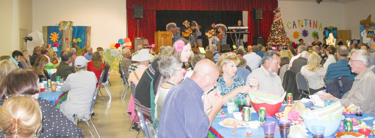 The room was full and the activities varied as a full house enjoyed the Quitman Pilot Club’s first ever Fiesta Extravaganza Feliz Navidad at the Carroll Green Civic Center. Some of the attendees enjoy their meal, others are having a good time visiting.