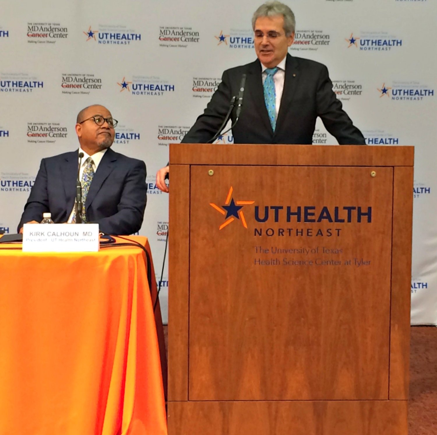 Dr. Ronald DePinho, at podium, discusses MD Anderson partnership with UT Health NE. At left is UT Health NE President Dr. Kirk Calhoun.