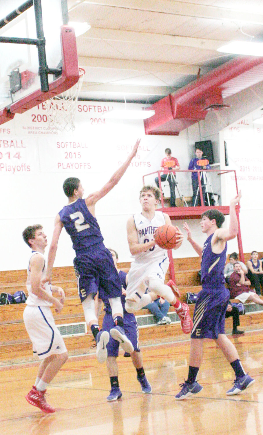 Shawn Davis is flying high through a trio of Eustace defenders as he drives to the basket last Tuesday night in Alba. The Bulldogs’ Ethan Austin (2) was able to fly just a bit higher and blocked Davis’ shot.  (Monitor photo by Tommy Anderson)