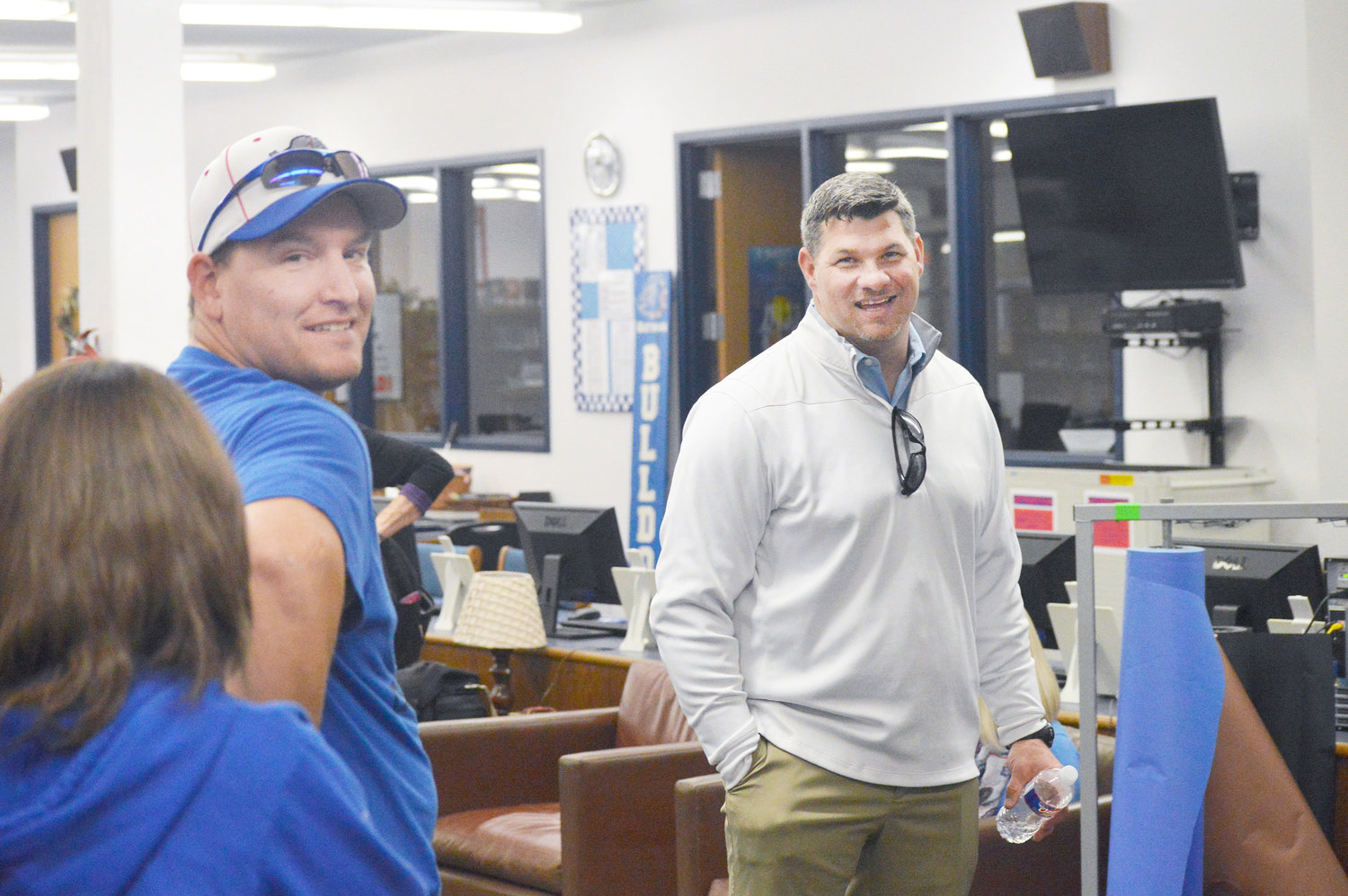 New Quitman Athletic Director and Head Football Coach Bryan Oakes visits with Brian Miller at Thursday’s “Meet the A.D.” gathering in the Quitman High School library. (Monitor photo by Larry Tucker)