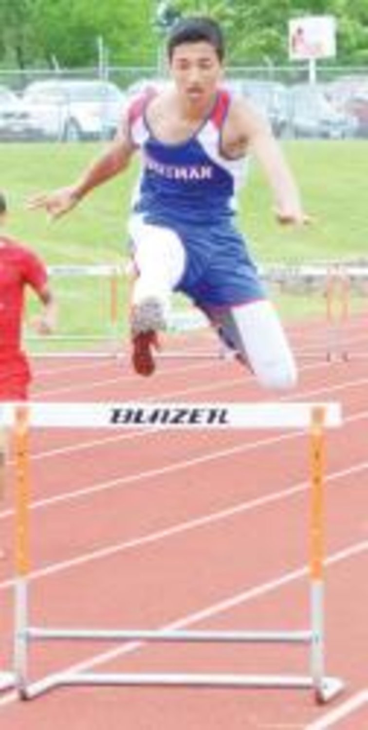 Stephen Love leaps over the last hurdle in district competition. (photo by Josh Land)
