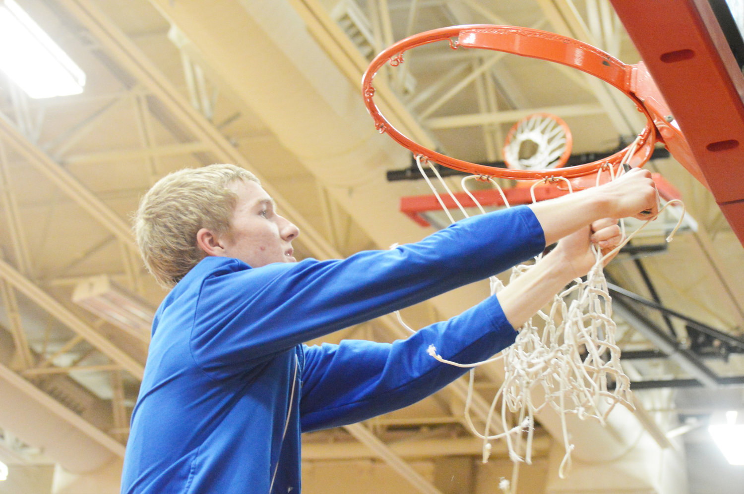Yantis senior Lucas Cerretani got the honor of cutting down the net after the Owls defeated Bellevue 50-45 for the area championship.