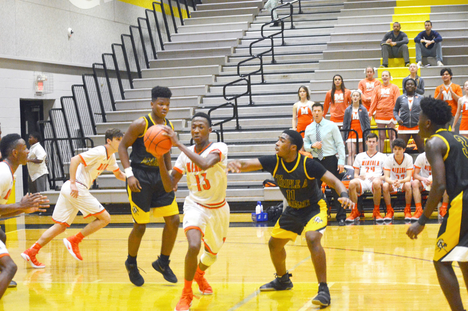 Mineola’s Shaw Franklin (13) gets ready to bounce pass after coming down with a defensive rebound in last Tuesday’s bi-district game against Triple A Academy.