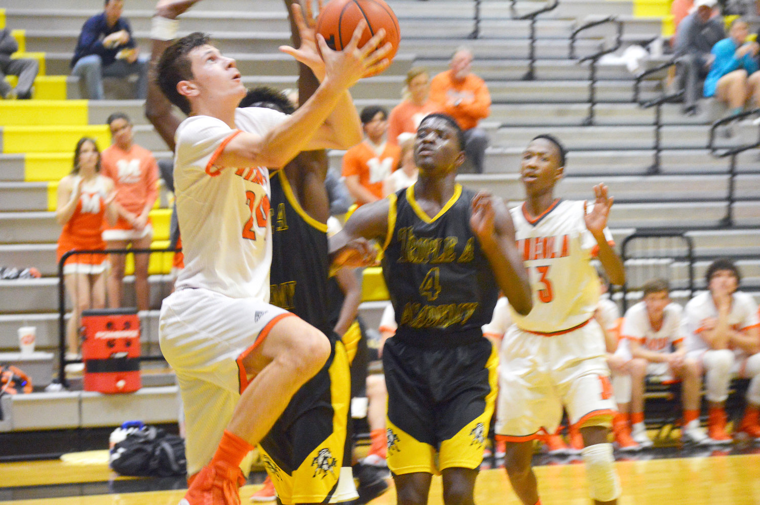Mineola’s Sean Dennis (24) attempts a reverse lay-up in the bi-district game played at Crandall against Triple A Academy.