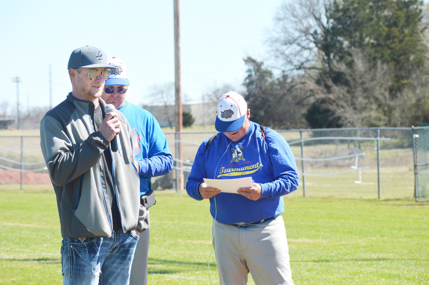 Hayes Peckham, star pitcher for the 2007 Quitman region quarter-final team which was honored at the alumni game Saturday, speaks to those gathered. Peckham went on to play baseball at Dallas Baptist University. Also pictured are Quitman Coach Lee LaPrade and Quitman Head Coach Hayland Hardy.