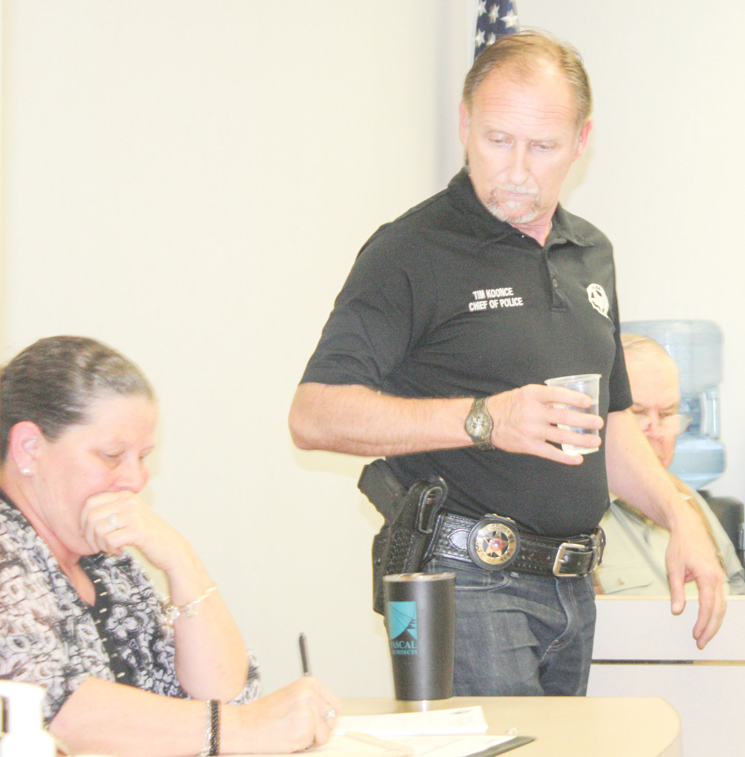 Alba Police Chief Tim Koonce looks on as Alba City Secretary Lindy McCarty goes over some paperwork just before the start of the Alba City Council monthly meeting last Monday night. Both Koonce and McCarty were listed on the agenda as topics of an executive session of the council.