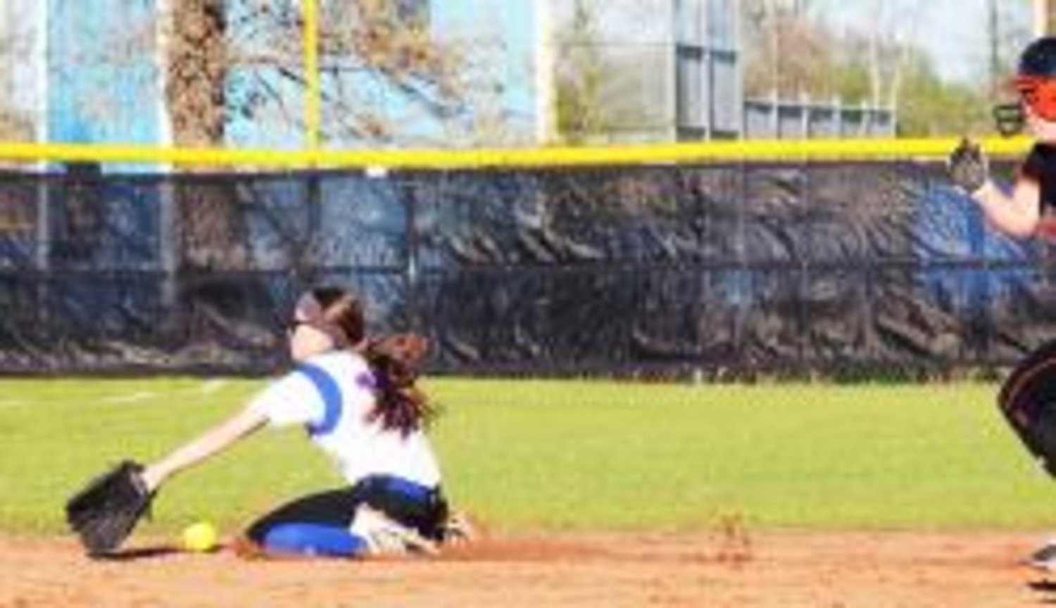 Quitman shortstop Alyssa Harris drops to her knees in a futile attempt to catch a hard hit ball to left field in the third inning Tuesday against Grand Saline.