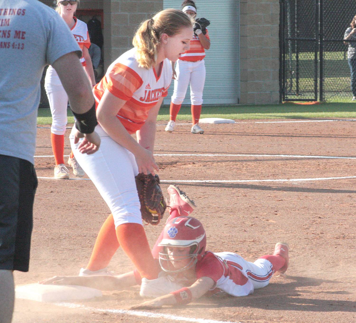 Alba-Golden’s Morgan Curtis slides back into first base safely under the tag of Mineola first baseman Eden Trent during the third inning of their game last Monday afternoon in Mineola.