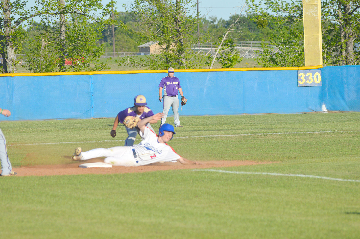 Quitman’s Ty Moss (2) slides safely underneath the tag at second base in the Bulldogs game against Eustace.