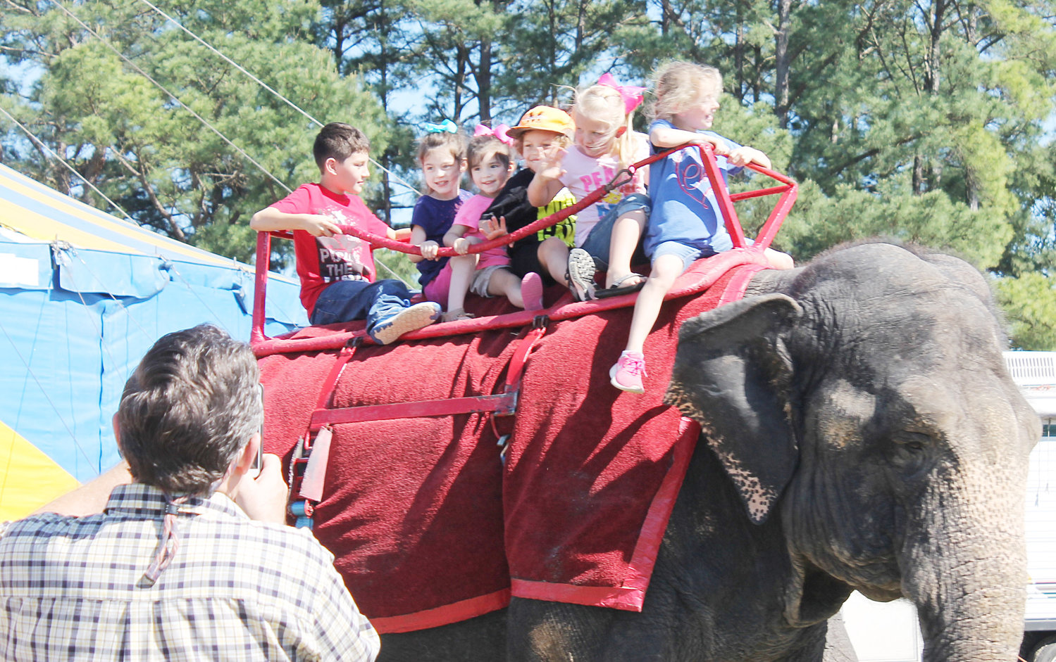 A group of children get the chance to see the world from a different angle atop the back of one of the pachyderms in Friday’s circus at the Mineola Civic Center.