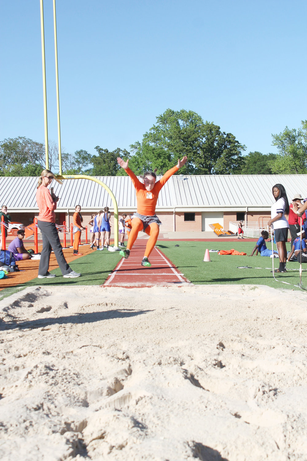 Emma Brian thrusts forward in the Long Jump Thursday and won  third place in the junior varsity division with a jump of 13’6”.