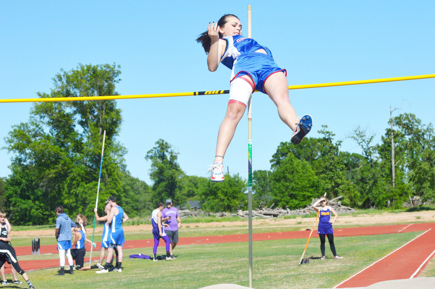Quitman’s Brittany Glover sails over the bar in the high jump Thursday at the Quitman Relays.