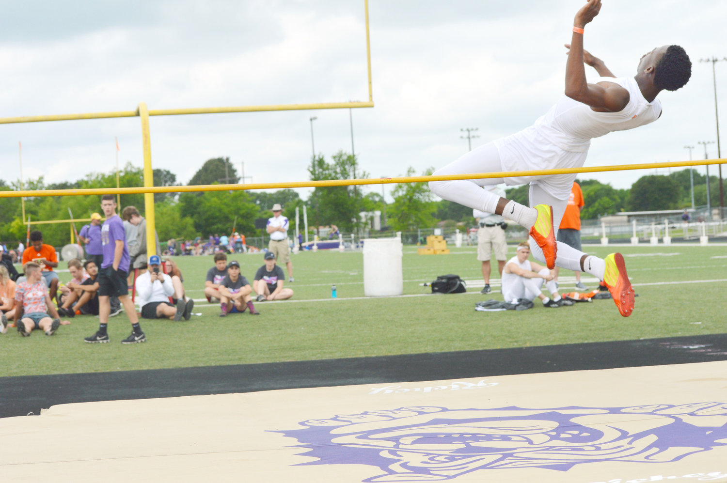 Mineola’s Shaw Franklin makes a flying attempt in the high jump at the district meet.