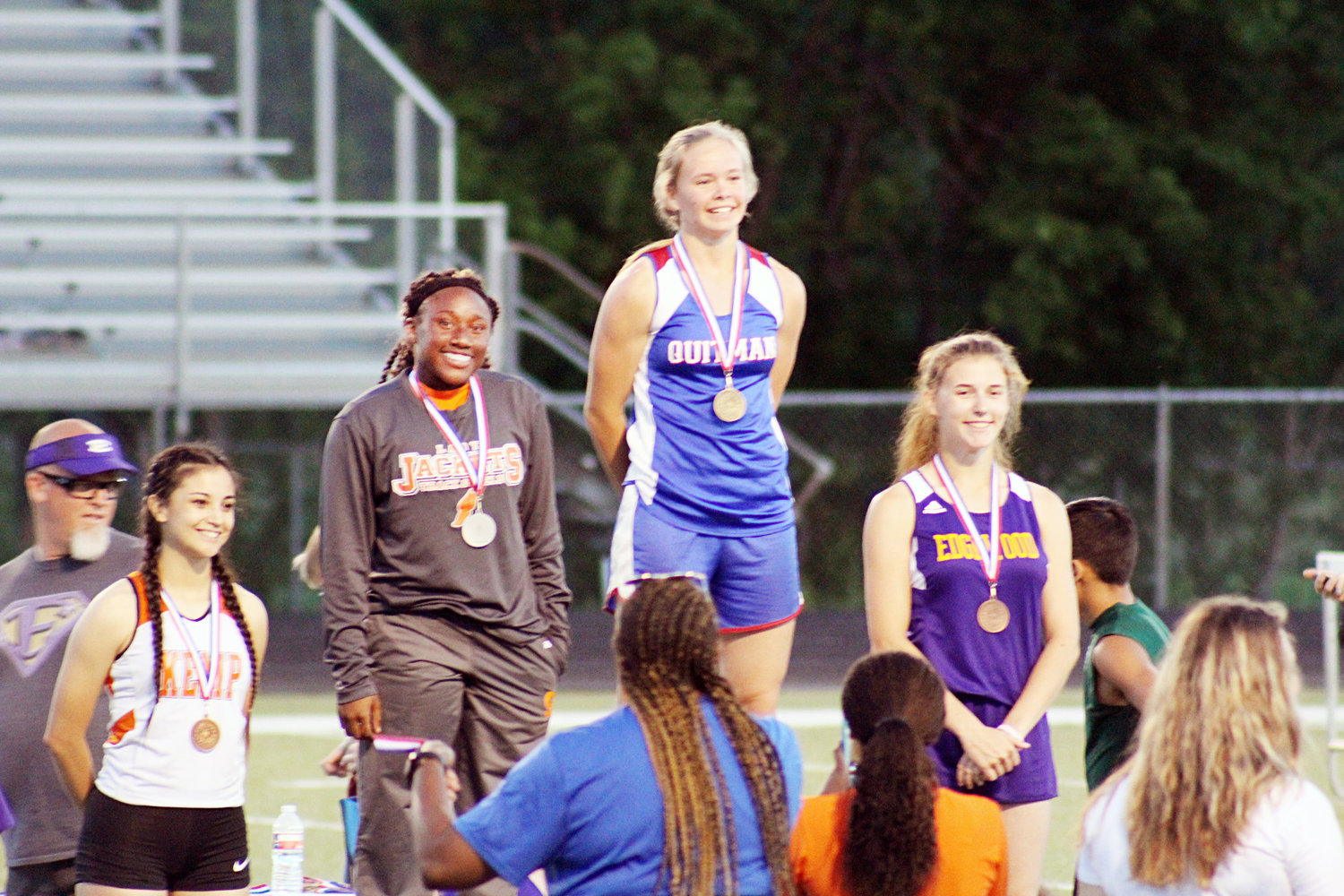 Madalyn Spears won first place in the 200M dash for the Quitman varsity team with a time of 27:05. To her left is second place winner from Mineola Jessiah Riley. (Monitor photo by Briana Harmon)