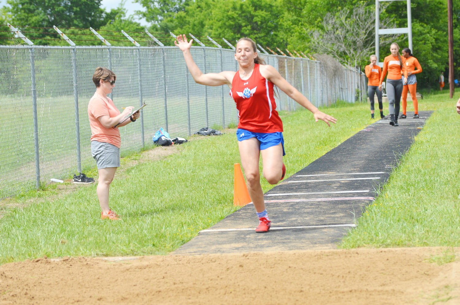 Alba-Golden’s Ashlyn Rogers makes a great effort in the triple jump at the district 12-3A trac meet last week at Eustace.