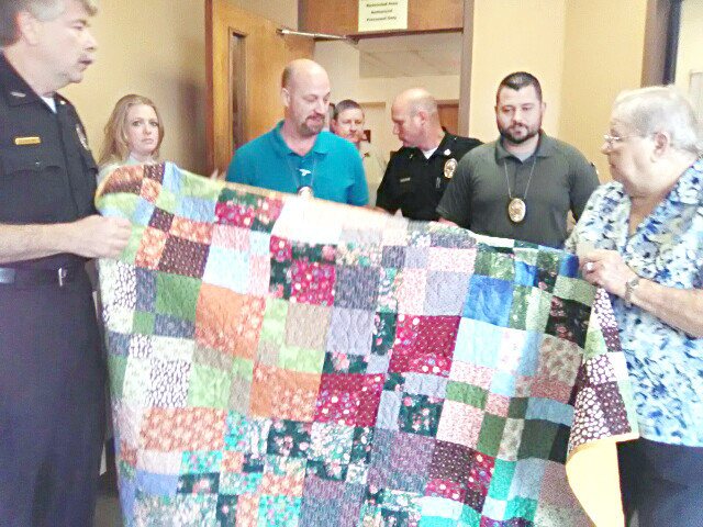 The recipients of gifts from the Quilt Guild included Mineola Police Department where a quilt and other items were given. Shown are, from left, Chief Chuck Bittner, Secretary Merci Thomas, Investigator Scott Gallimore, Investigator Jim Lewman, Captain Dusty Cooke, Investigator Josh O’Grady and Betty Napier.