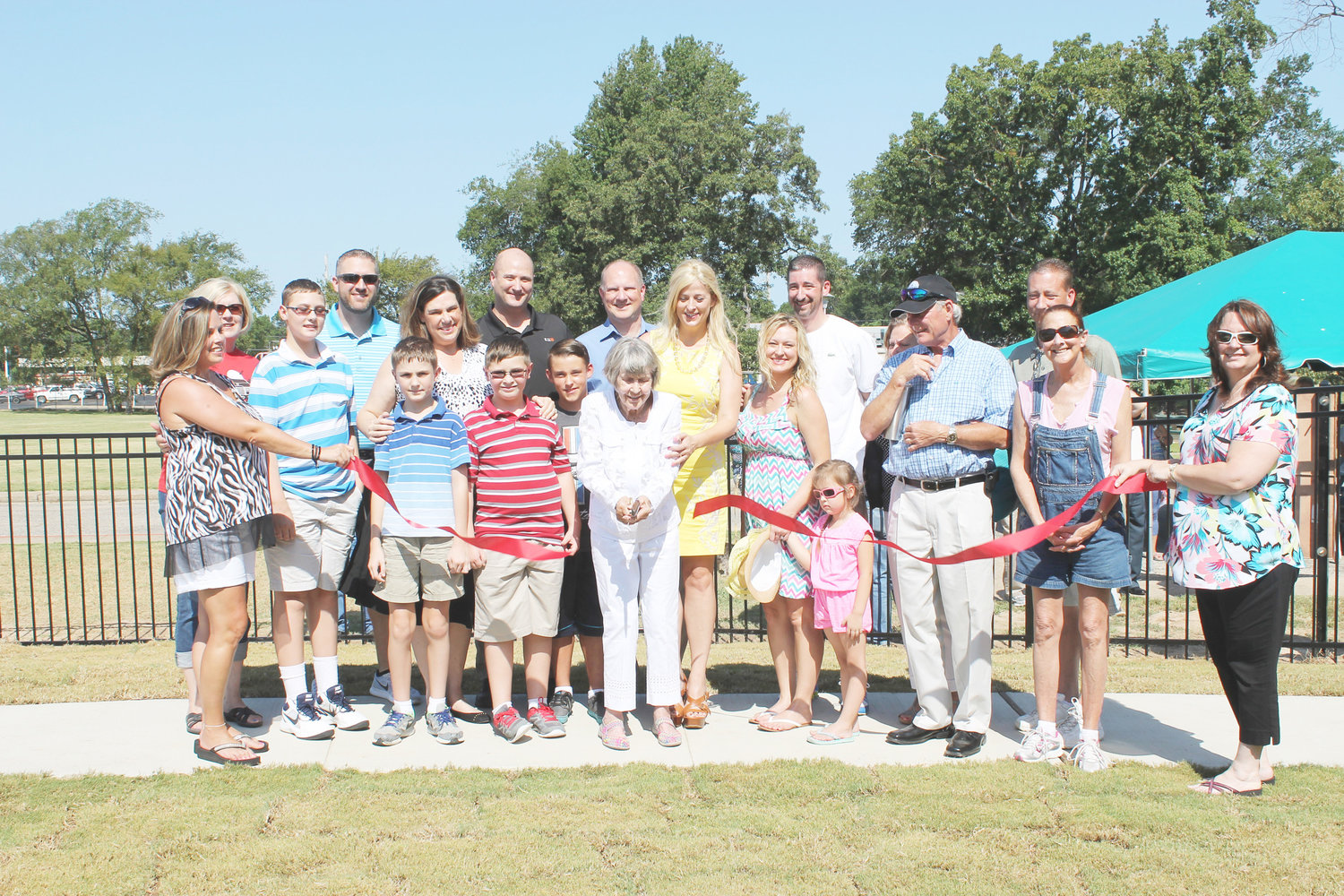 Rheba Myers, backed by many family members as well as Mineola Chamber of Commerce representatives, showed how a ribbon cutting is supposed to be done.
