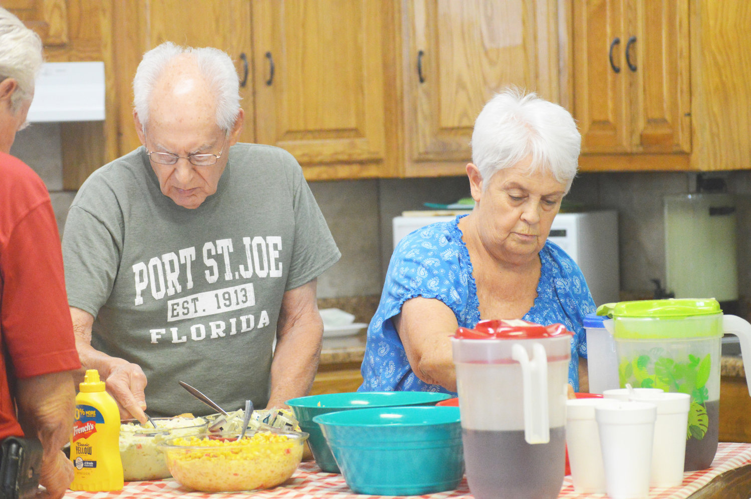 Jack and Pat Neel fill their plates at Friday’s Forever Young Activity Center luncheon. Monitor photo by Larry Tucker)