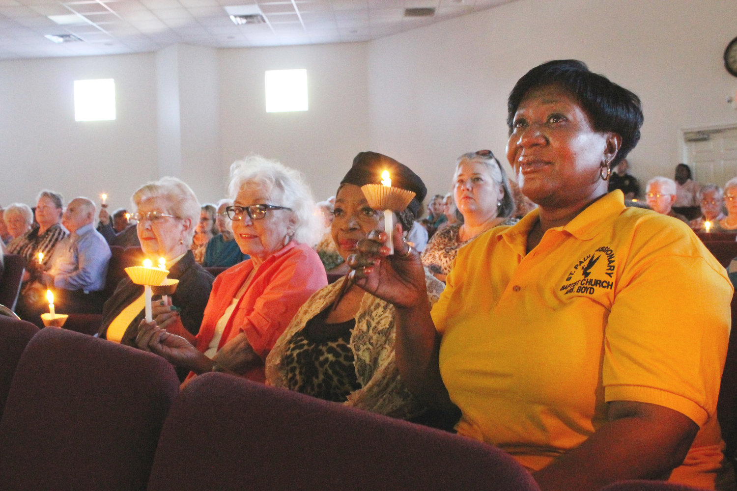 Gwen Stirman, Claudene Sublett, Brenda Beedles and Kathy Boyd reflect on the reason for the Community Prayer Vigil Sunday evening at St. Paul Baptist Church. Kathy Elmore is seated behind them and her face also shows the solemnity of the occasion. (Monitor photos by Doris Newman)