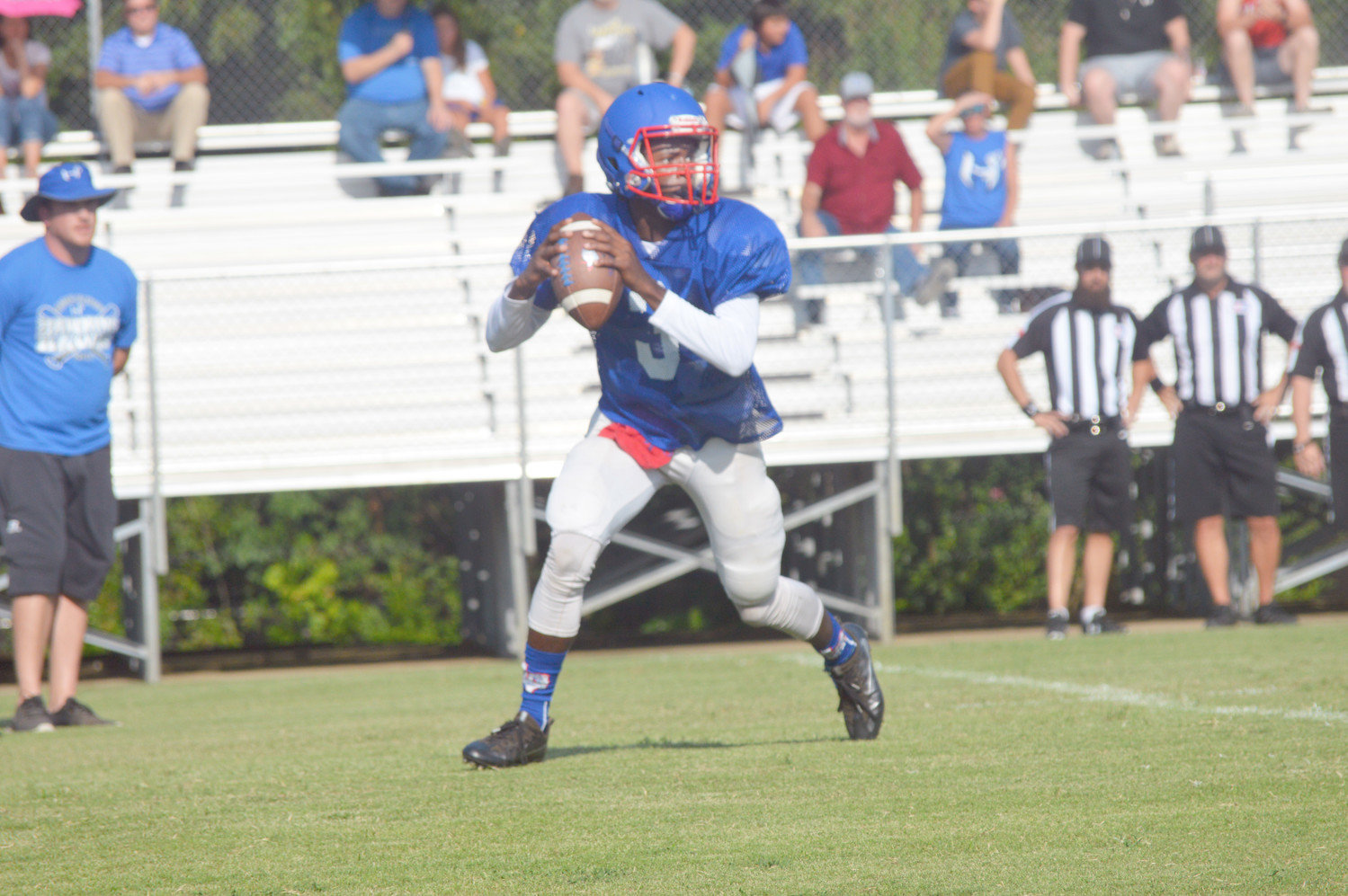 Trey Berry (3) rolls out to throw a pass in Quitman’s scrimmage against Hawkins last Thursday.