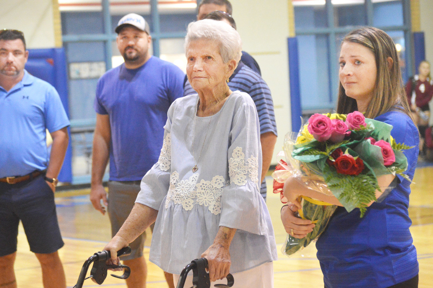 Former Quitman volleyball coach Pat Neighbors is pictured here with current QHS Coach Ashlee Lingo during ceremonies honoring her last Tuesday. Her four grandsons are in the background.