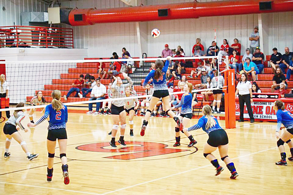 Quitman freshman middle blocker Ava Burroughs continues to impress on varsity. She is shown here going for a kill at Lone Oak last Friday.
