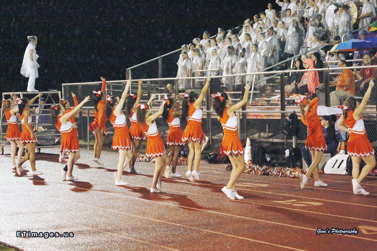 Mineola cheerleaders and band fought the rain to cheer on the Yellowjackets at Farmersville.