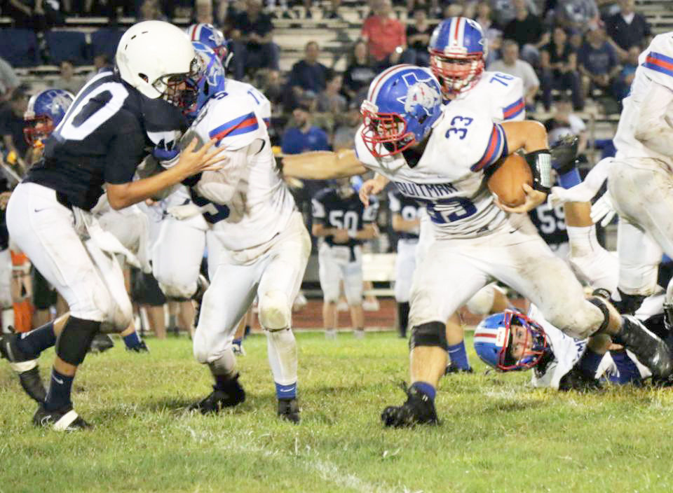Quitman’s Alex Wilson (33) runs behind the blocking of Ty Holland (5) in Friday’s game at Union Grove.