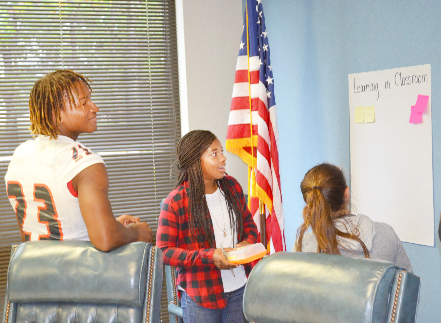From left, Trevion Sneed, Abby Kratzmeyer and Lilyanne Windle post suggestions for how to improve learning in the classroom. (Monitor photos by Hank Murphy).