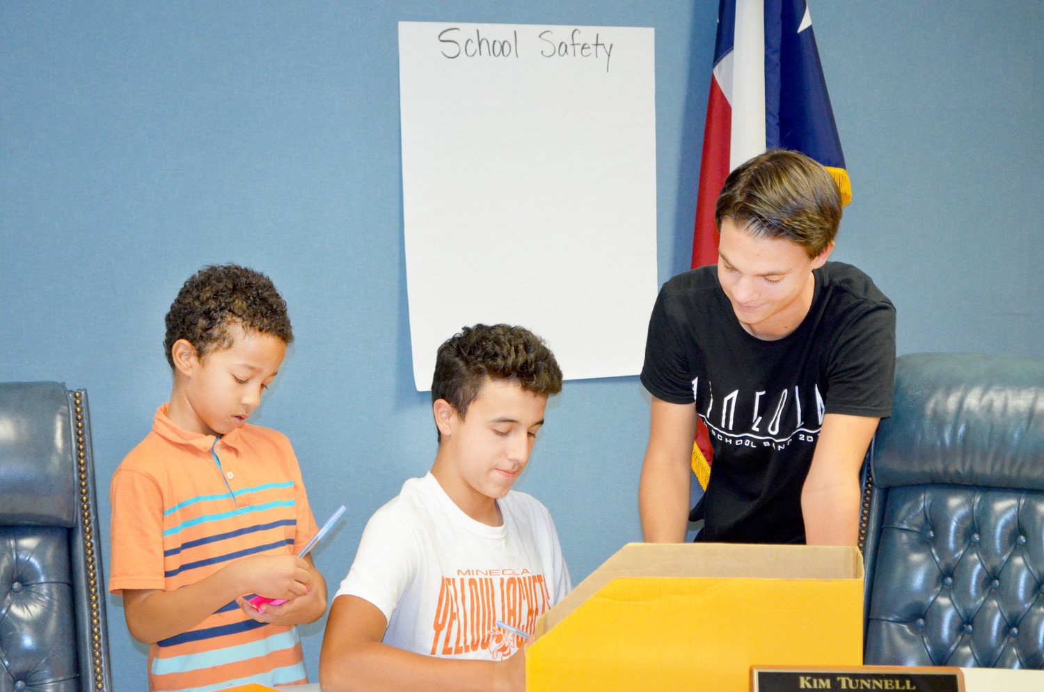 From left, third-grader Kenneth Jackson, eighth-grader Alex Barriga and senior Jackson VanDover consult over the issue of school safety during the inaugural meeting of the Mineola Student Advisory Council.