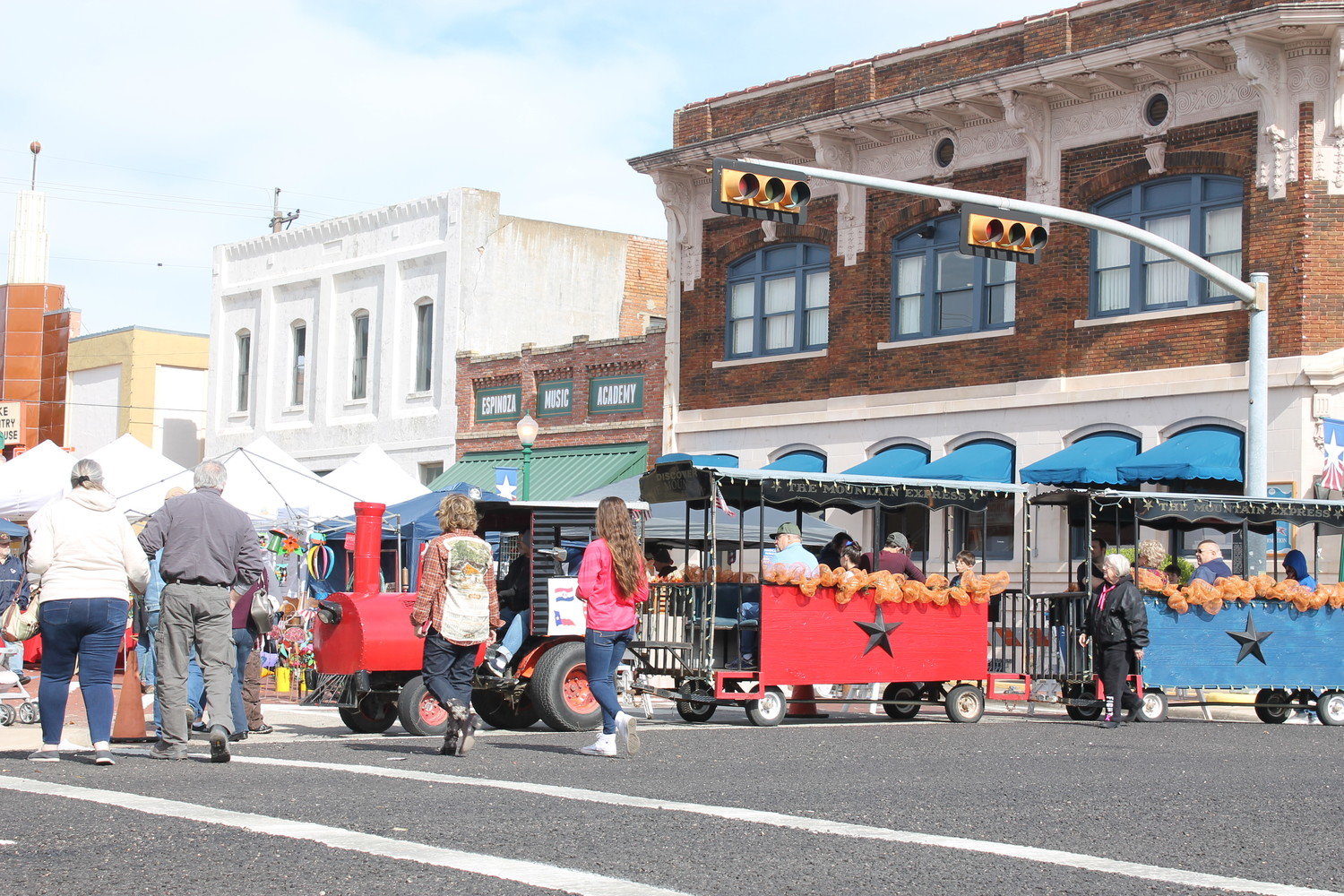 A miniature train carries its passengers on Johnson Street during last year’s Iron Horse Heritage Festival in downtown Mineola. (Monitor file photo)