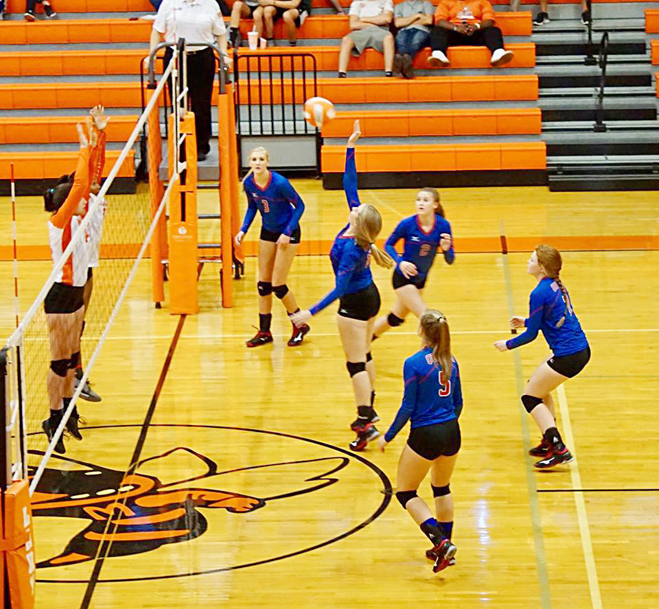 Quitman’s Maddy Whitehurst goes up for a kill over Lady Jacket middle blockers in last week’s district game at Mineola won by Quitman.