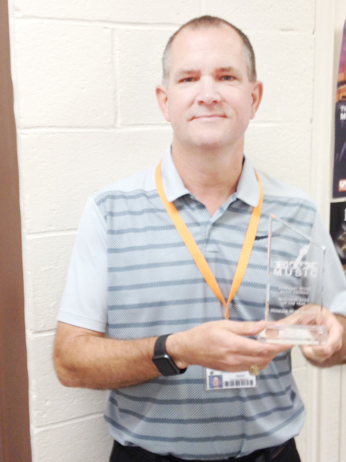 Mineola Band Director Chris Brannon and the East Texas Music Awards trophy.