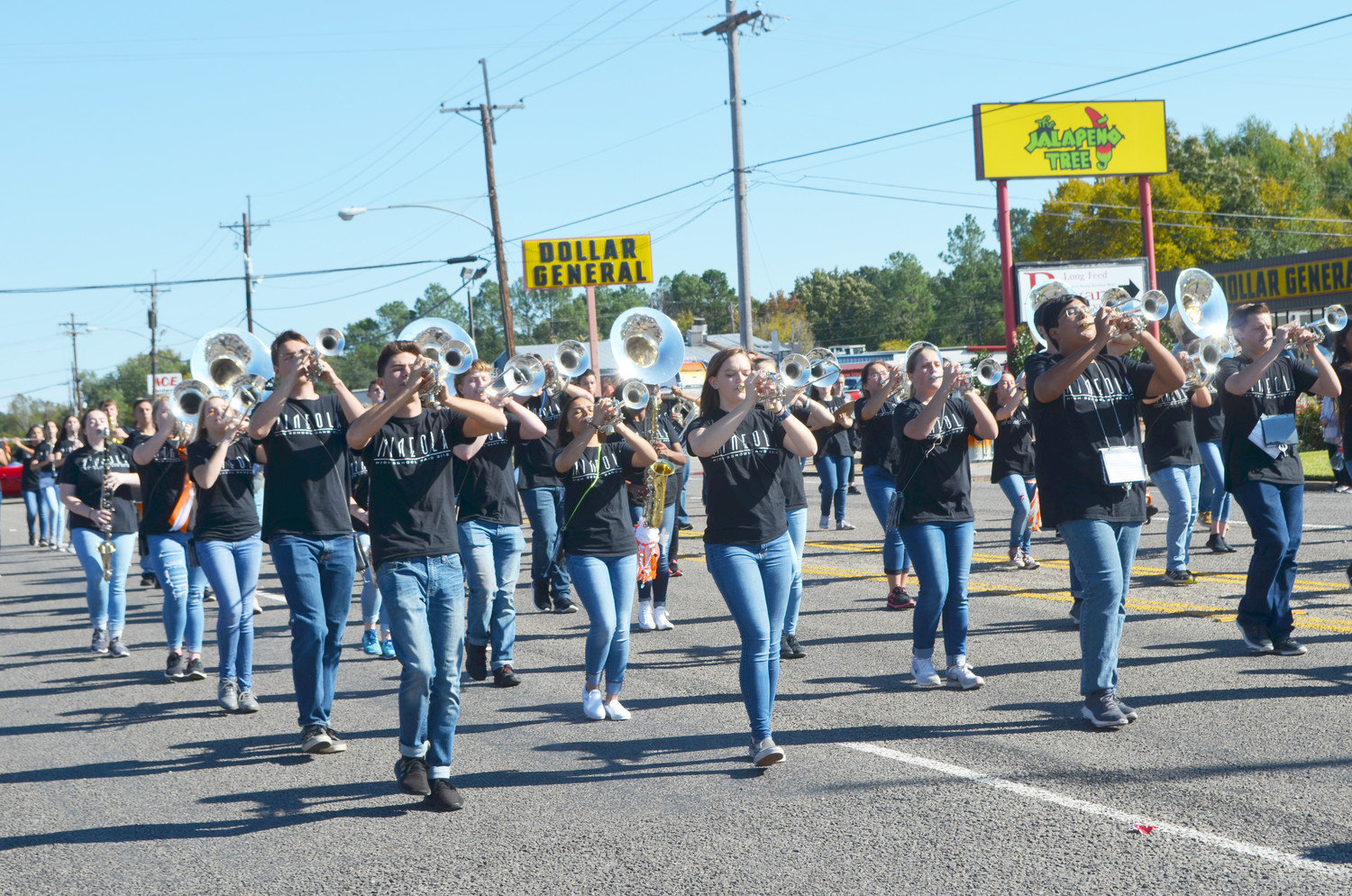 Members of the Mineola High School Marching Band make music along the Homecoming Parade route on Friday.