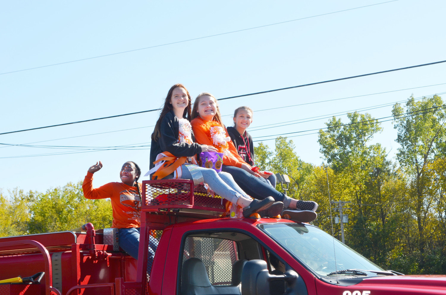 These young ladies show their school spirit aboard a fire truck during Mineola High School’s Homecoming Parade on Friday.