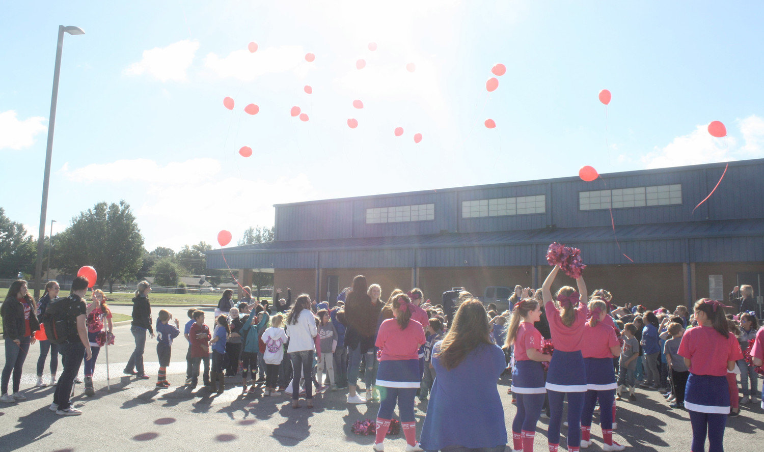 Quitman Elementary students release red balloons for Red Ribbon Week, which teaches kids about not using drugs, in the QES parking lot on Oct. 26. High school student leaders came to the elementary to lead the balloon release.  (Monitor photo by Zak Wellerman)