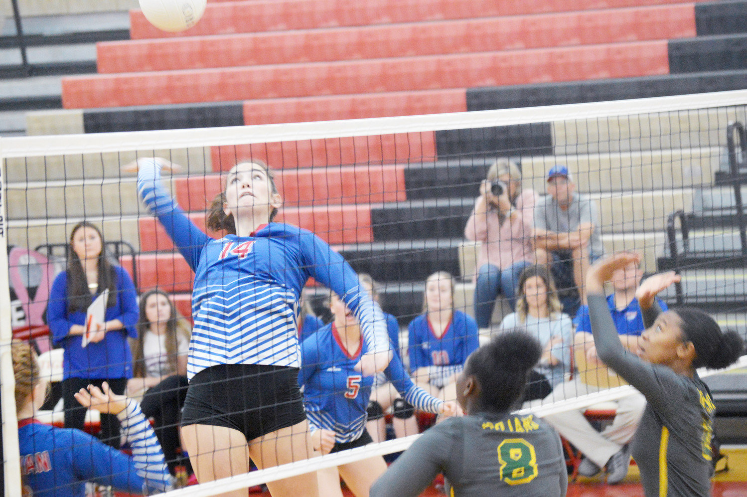 Quitman freshman middle blocker Ava Burroughs goes high for a kill in bi-district action against Dallas Madison last week. (Monitor photo by Larry Tucker)