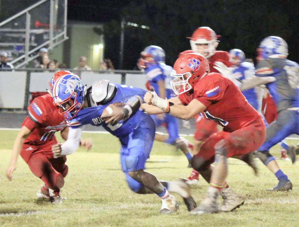RIGHT: Quitman quarterback Trey Berry is brought down by Alba-Golden’s Dylan Arenas (11) in the Panthers 60-22 win over the Bulldogs. (Photo by Sheree Phillips)