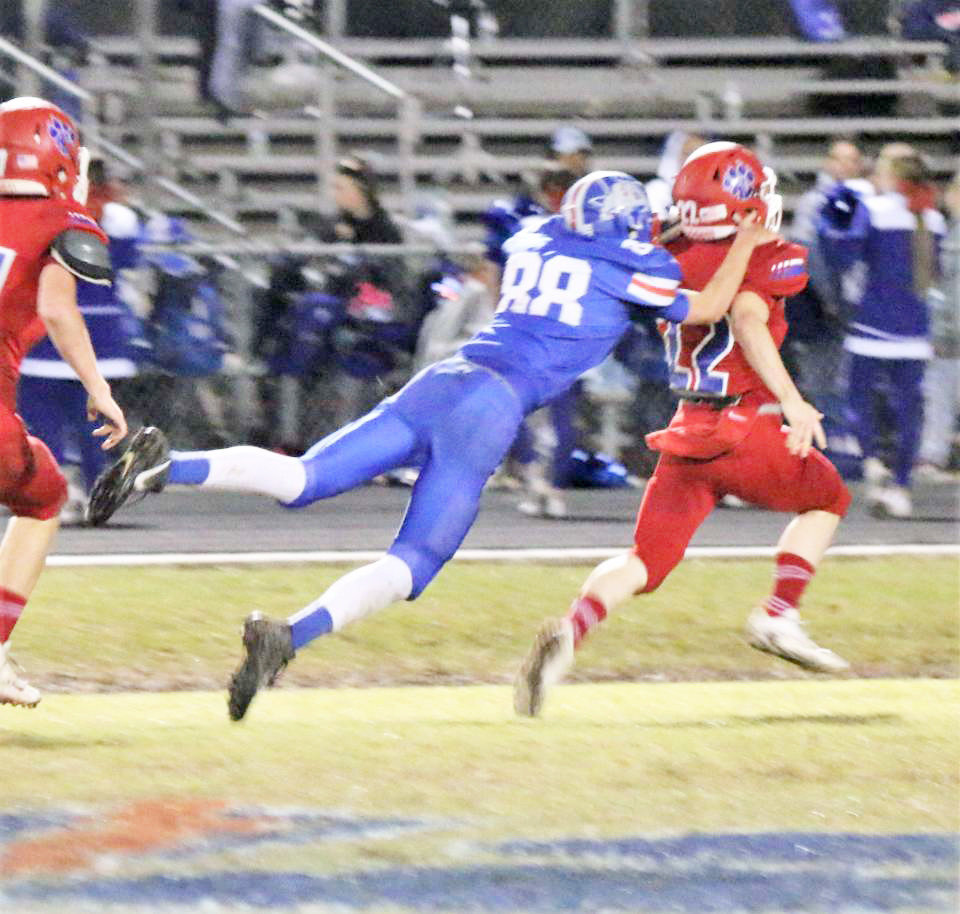 Quitman’s Rylie Flanagan (88) flies to make a touchdown saving shoestring tackle on Alba-Golden’s Austin Hartley. (Photo by Sheree Phillips)